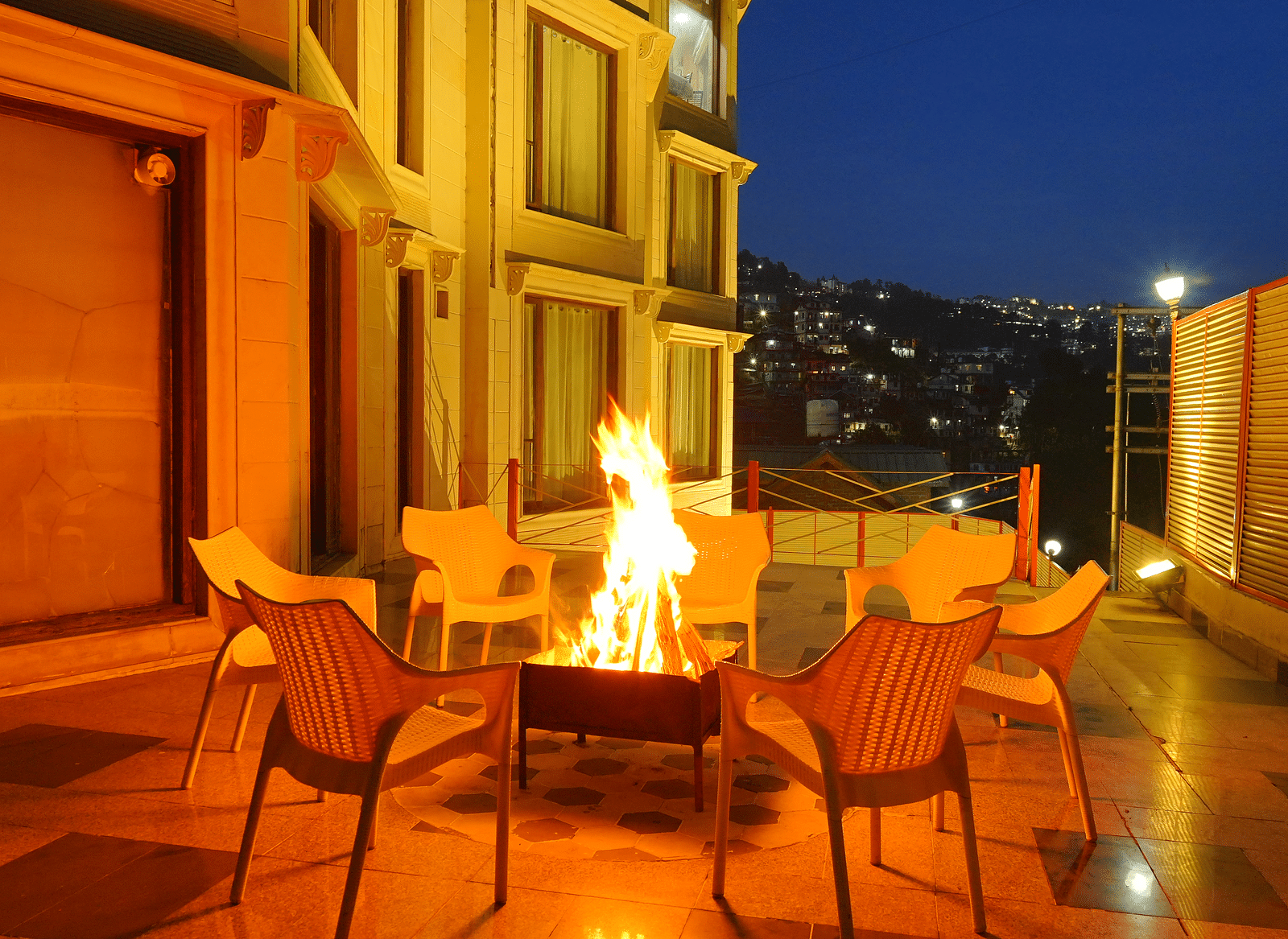 A bonfire with chairs arranged around it at DLS Hotels The Rock Castle